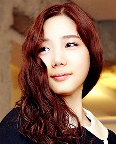 点击大图看下一张：韩系妩媚知性发式，将卷烫后的头发侧放到一边，深深的流露出了女人的性感，采用酒红发色更佳透露出性感妩媚的味道。工作的时候扎成一个马尾也韩味十足噢。