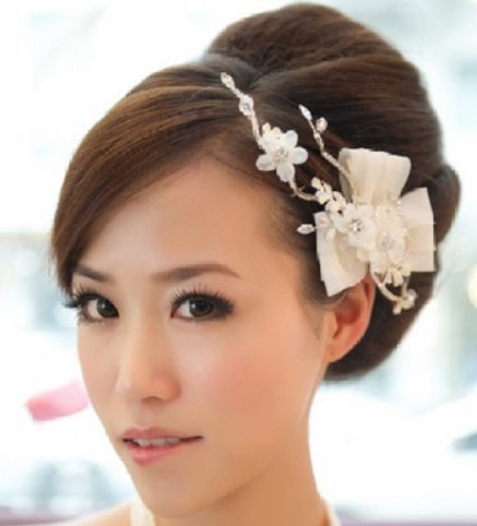 点击大图看下一张：这款中式古典新娘盘发发型近来非常流行，漂亮的头发设计弧度，优雅的曲线，赋予新娘子大气端庄的气质魅力。