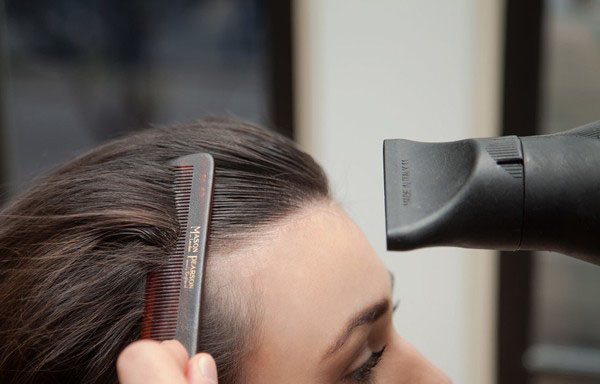 点击大图看下一张：Step 1:首先你要打造一个光滑的刘海，在头发上抹上摩丝后，用细齿梳梳发，让每一缕发丝都清晰可见，用吹风机沿着发丝根部吹过。热量有助于头发的塑型。