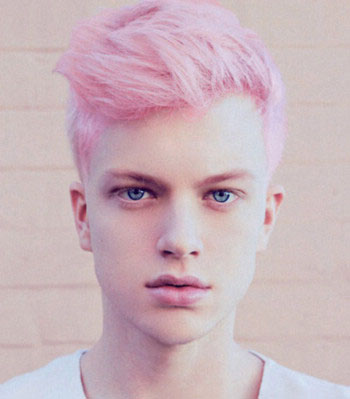 点击大图看下一张：同样是一款粉红色的沙宣男士短发造型，这种粉嫩的颜色与露额式的短发造型，一侧的颊光更是凸显男生的帅气与个性感，白皙的肤色更显小正太的姿态感哦。