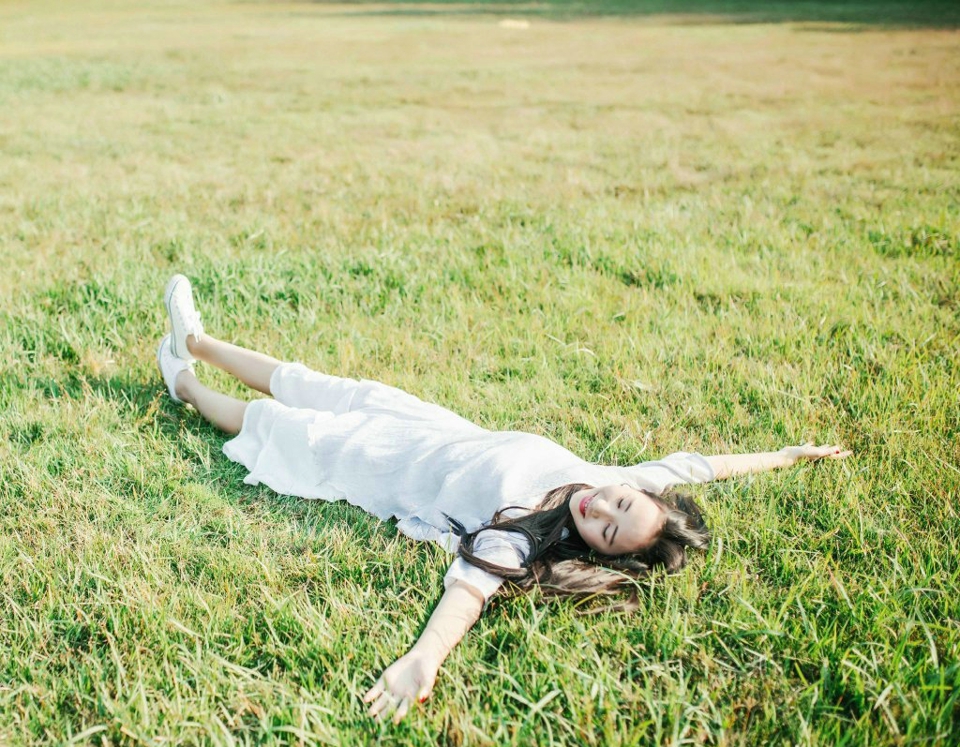 点击大图看下一张：草地上的长发女神散发淳朴笑容