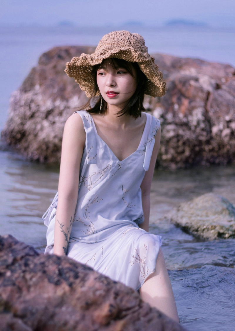 点击大图看下一张：海岸边的草帽美女柔美可人写真