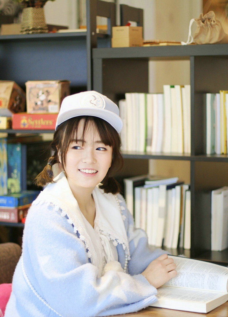 点击大图看下一张：图书馆内的棒球帽呆萌妹子笑容甜美