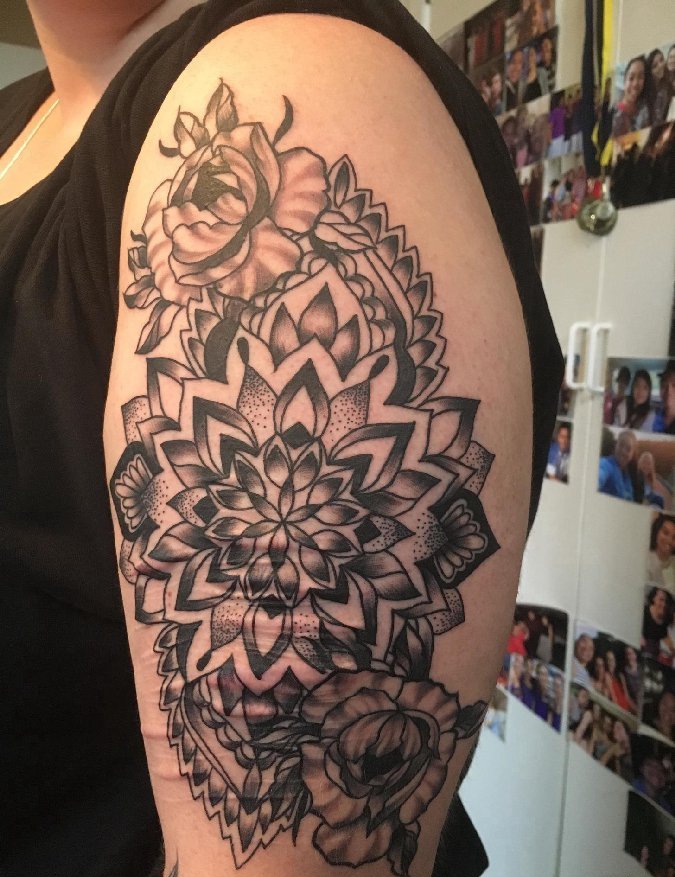 点击大图看下一张：女性左手大臂上遮盖伤疤的精致的花卉纹身图片