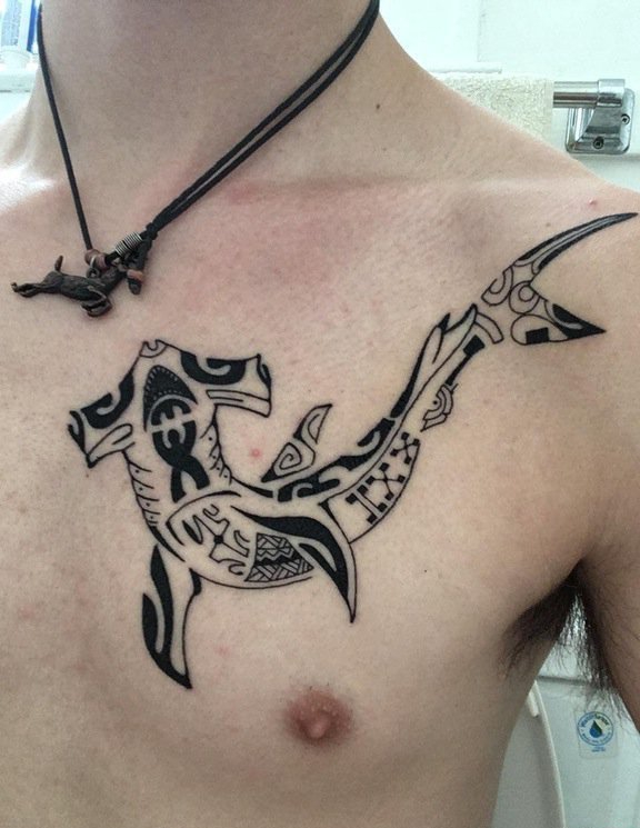 点击大图看下一张：男性左胸部上黑色的几何鱼纹身图片