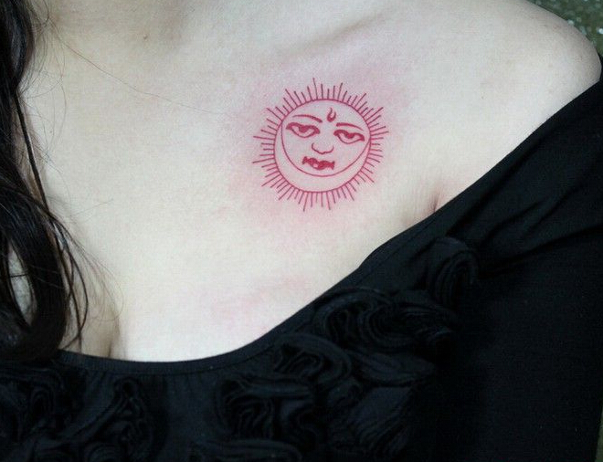 点击大图看下一张：美女胸部红色的太阳图腾个性纹身