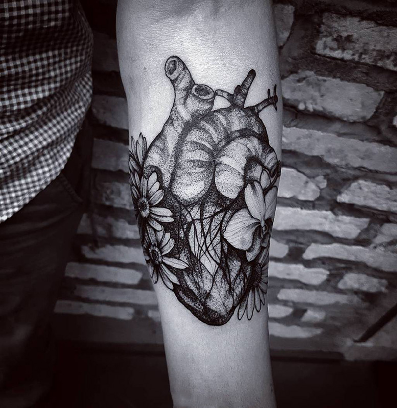 点击大图看下一张：手臂好看的心脏与花卉点刺纹身
