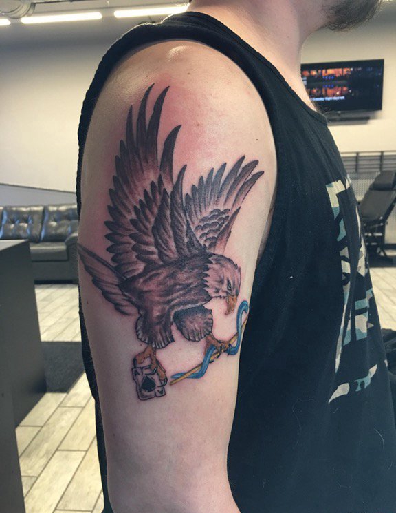点击大图看下一张：男孩右手大臂膀上的黑灰色老鹰纹身图片
