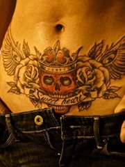 美女腹部时尚的戴皇冠的骷髅纹身图案