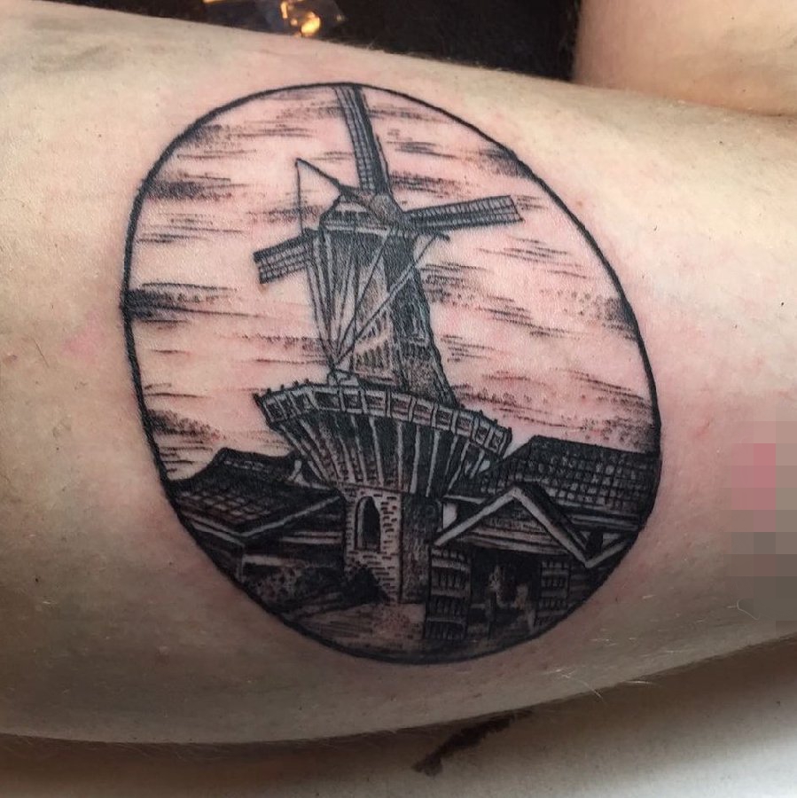 点击大图看下一张:女生小腿上黑色素描点刺技巧建筑风车纹身图片