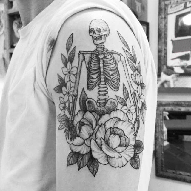 点击大图看下一张：男生大臂上黑灰点刺简单线条花朵和骷髅骨架纹身图片