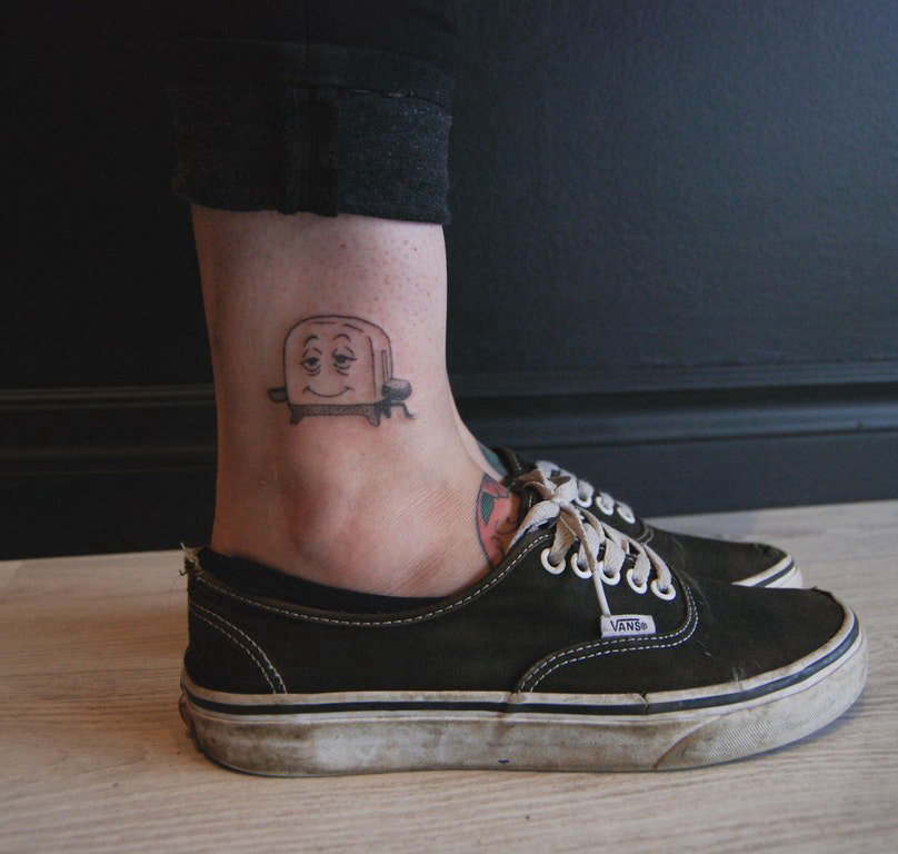 点击大图看下一张：女生脚踝上黑灰点刺简单线条卡通烤箱纹身图片