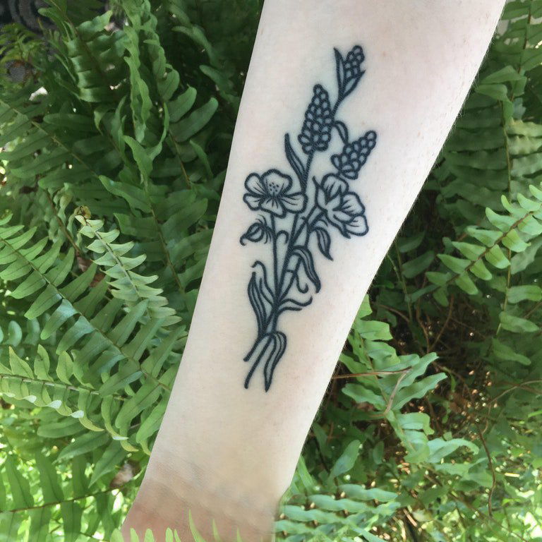 点击大图看下一张：紫罗兰花纹身 女生手臂上黑色的文艺花朵纹身图片