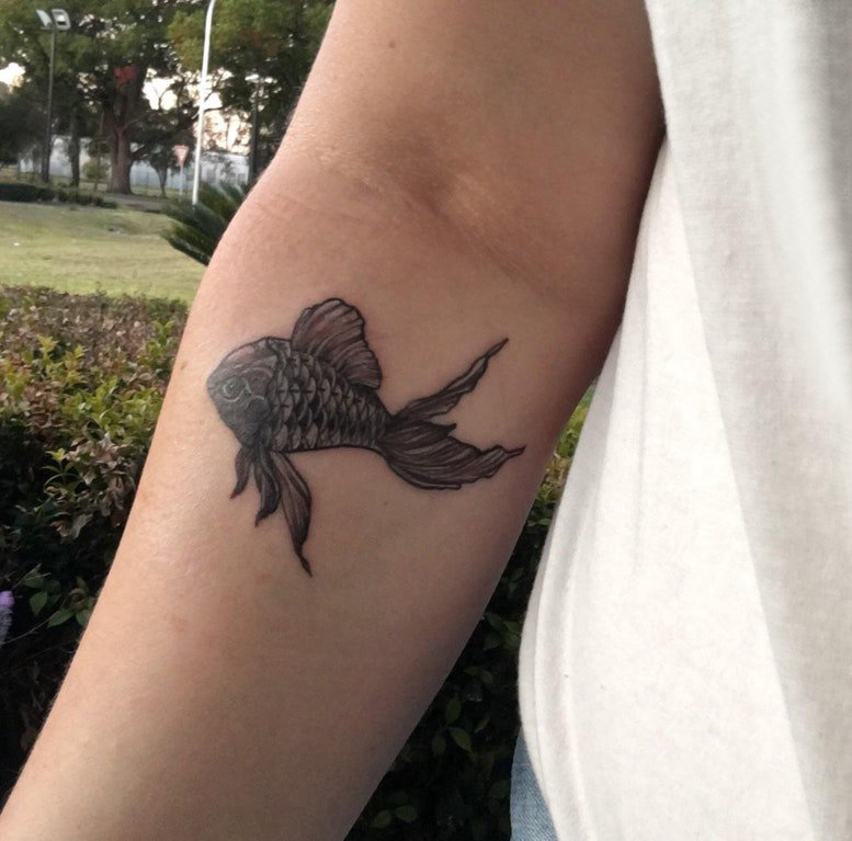 点击大图看下一张：黑色金鱼纹身 男生手臂上黑色的金鱼纹身图片