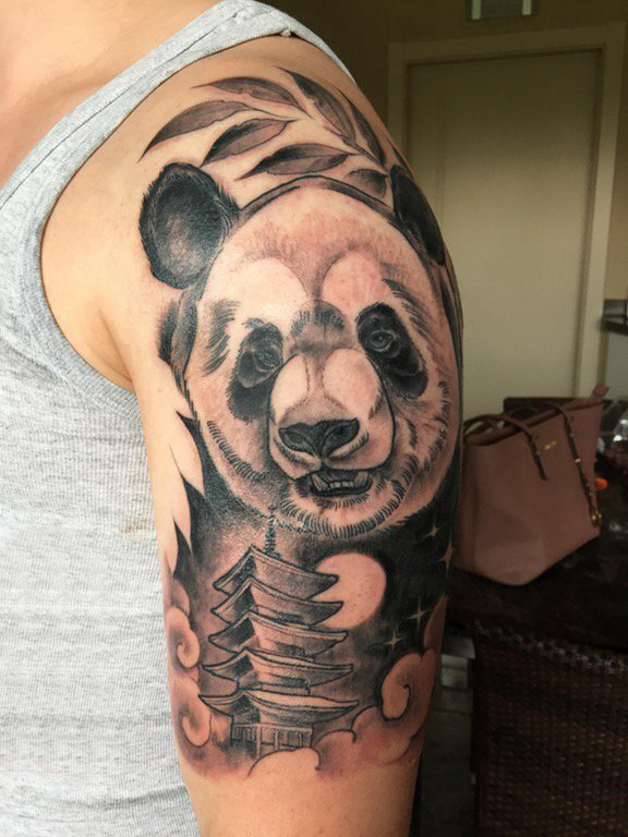 点击大图看下一张：熊猫纹身图 男生大臂上黑色的熊猫纹身图片