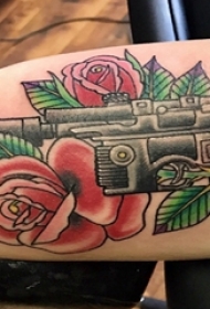 纹身枪 男生手臂上玫瑰花和枪纹身图片