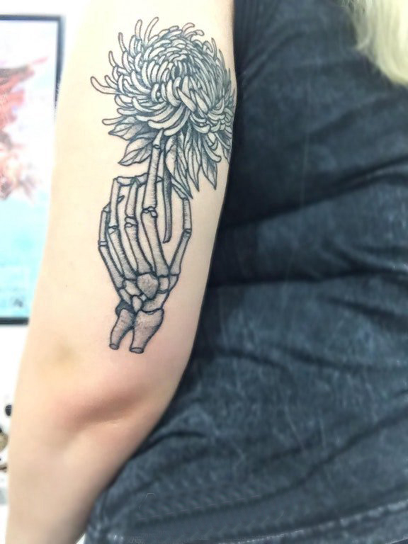 点击大图看下一张：黑灰写实纹身 女生手臂上骨头和花朵纹身图片