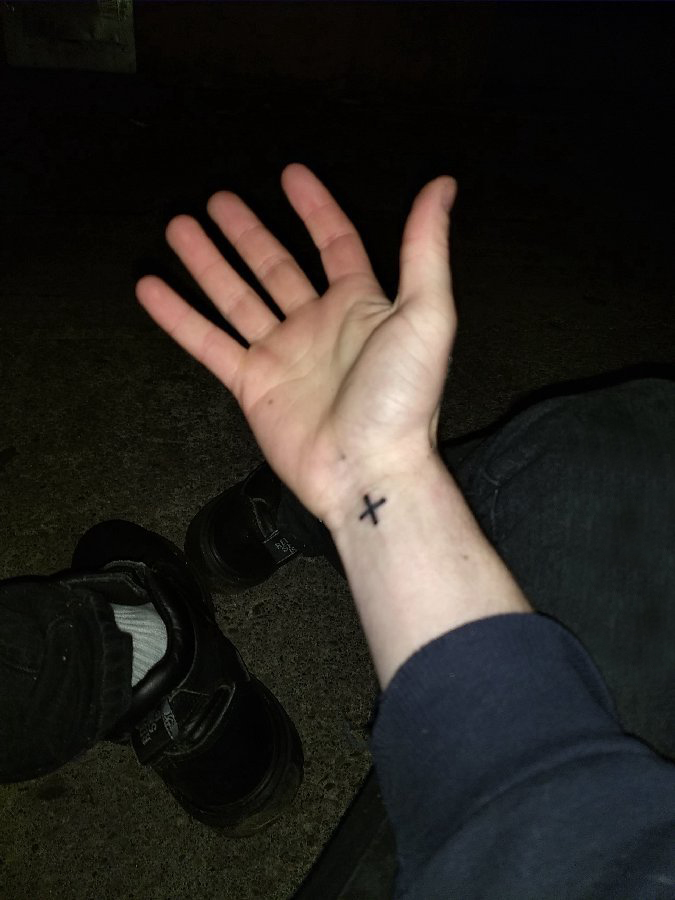 点击大图看下一张：简单线条纹身 男生手腕上黑色的十字架纹身图片