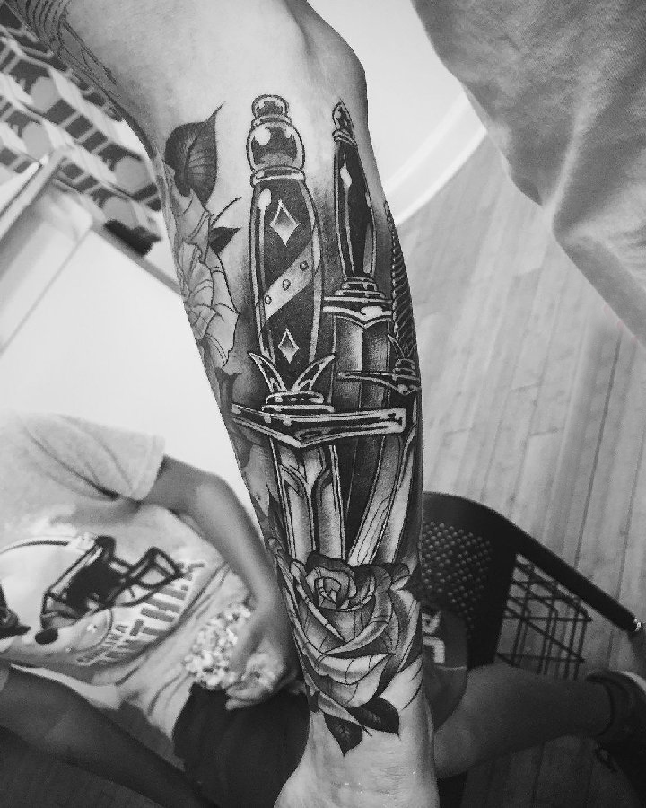 点击大图看下一张：纹身黑色 男生手臂上玫瑰和匕首纹身图片