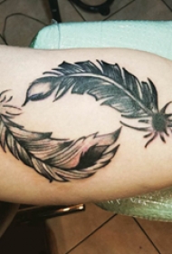 纹身点刺技巧 男生大臂上黑色的羽毛纹身图片
