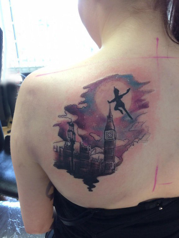点击大图看下一张：女生后背纹身图 女生后背上小精灵和建筑物纹身图片