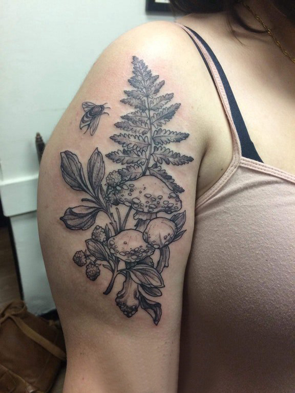 点击大图看下一张：植物纹身  女生大臂上黑灰的植物纹身图片