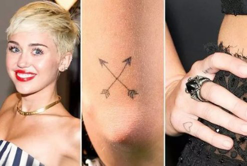 点击大图看下一张：美国纹身明星  Miley Cyrus手臂上黑色的极简纹身图片