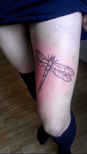点击大图看下一张：蜻蜓纹身图案 女生大腿上黑色的极简纹身图片