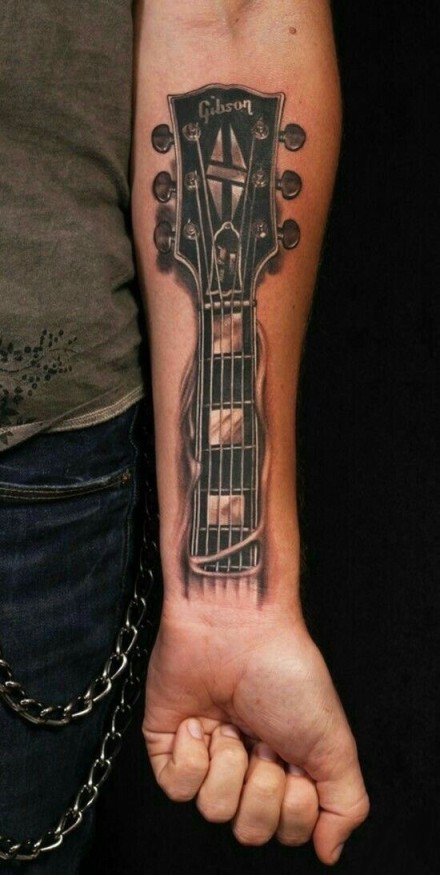 点击大图看下一张：9张适合吉他手的吉他纹身图案