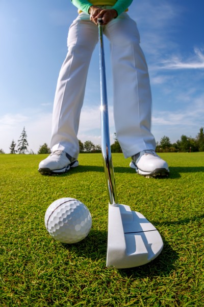 点击大图看下一张：草地打高尔夫的男人图片