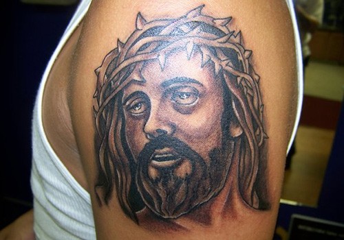 点击大图看下一张：手臂上一款个性的耶稣头像纹身