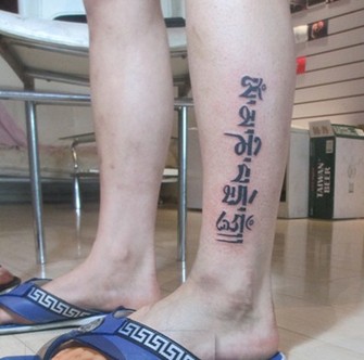 点击大图看下一张：男人腿部时尚的梵文刺青