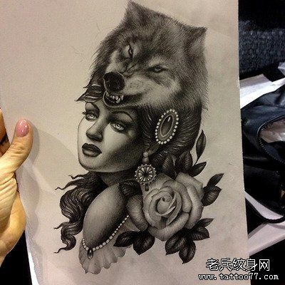 点击大图看下一张：一款狼头女郎纹身图案