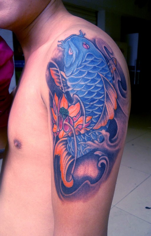 点击大图看下一张：蓝色锦鲤和莲花的手臂纹身图案