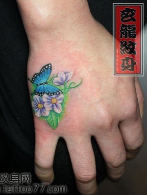 点击大图看下一张：美女手背彩色蝴蝶花卉纹身图片