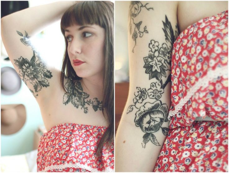 点击大图看下一张：女生手臂上漂亮的花朵图腾纹身