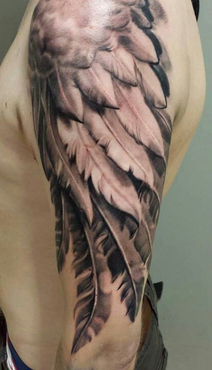 点击大图看下一张：手臂上的羽毛纹身