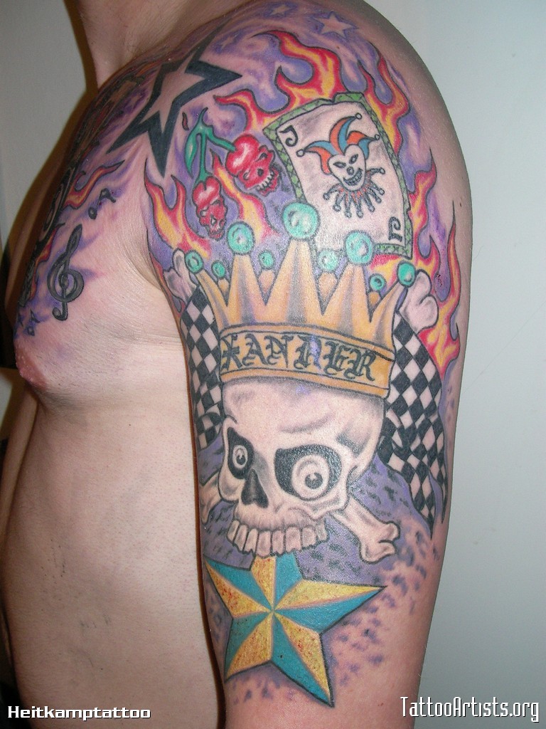 点击大图看下一张：大臂上骷髅国王纹身