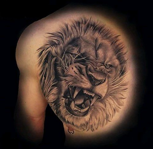 点击大图看下一张：手臂上威猛霸气的唐狮纹身