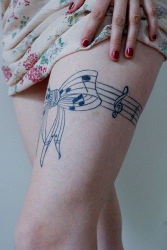 点击大图看下一张：女性腿部蝴蝶结音符纹身