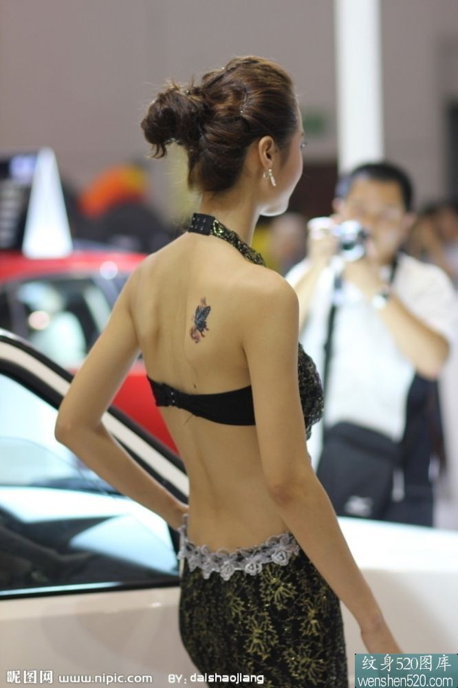 点击大图看下一张：后背上有小清新纹身图案的车模