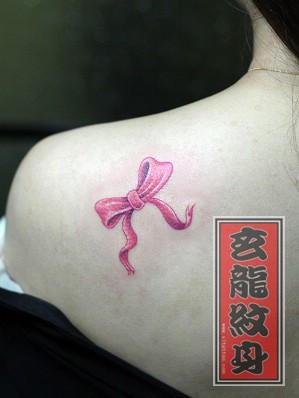 点击大图看下一张:女人喜欢的肩部彩色蝴蝶结纹身图片