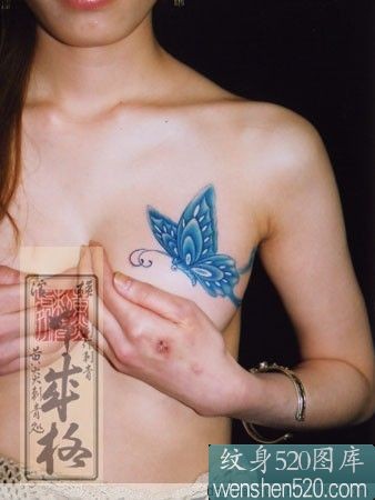 点击大图看下一张：女子胸前蓝色蝴蝶纹身作品