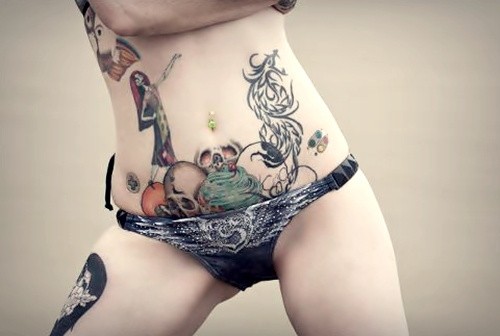 点击大图看下一张：女子腰腹部漫画风格骷髅纹身