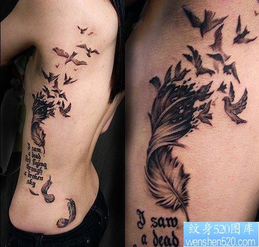 点击大图看下一张：一幅腰部羽化燕字母纹身图片由纹身520图库推荐