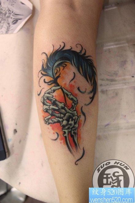 点击大图看下一张：女人腿部唯美的骷髅手与羽毛纹身图片