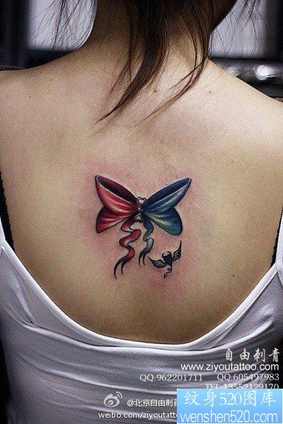 点击大图看下一张：女人后背时尚小巧的蝴蝶结纹身图片