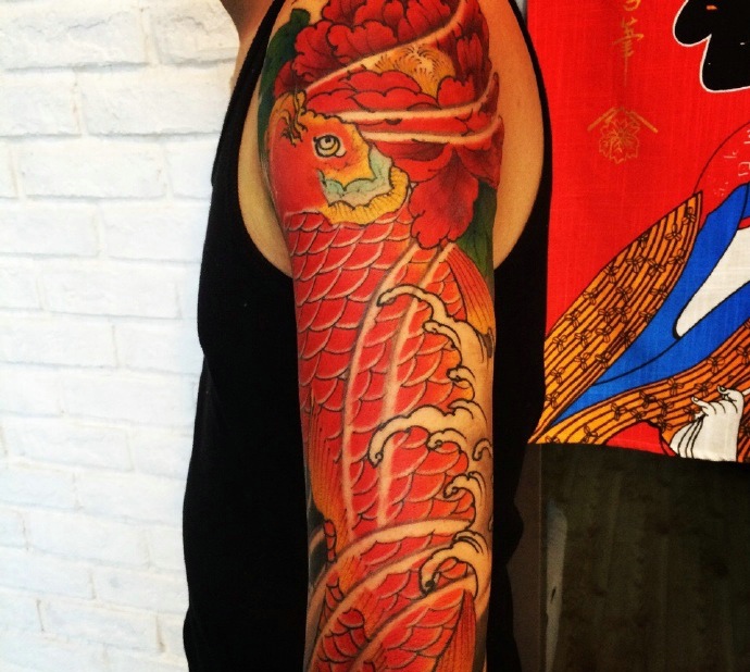 点击大图看下一张：大臂红鲤鱼纹身图片回头率极高(3/4)