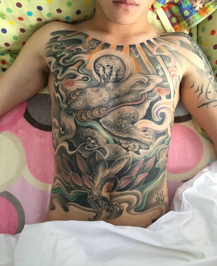 点击大图看下一张：个性男士胸前遮满了另类纹身图案