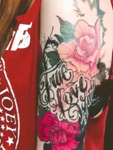 被花朵包围的英文单词花臂纹身图片